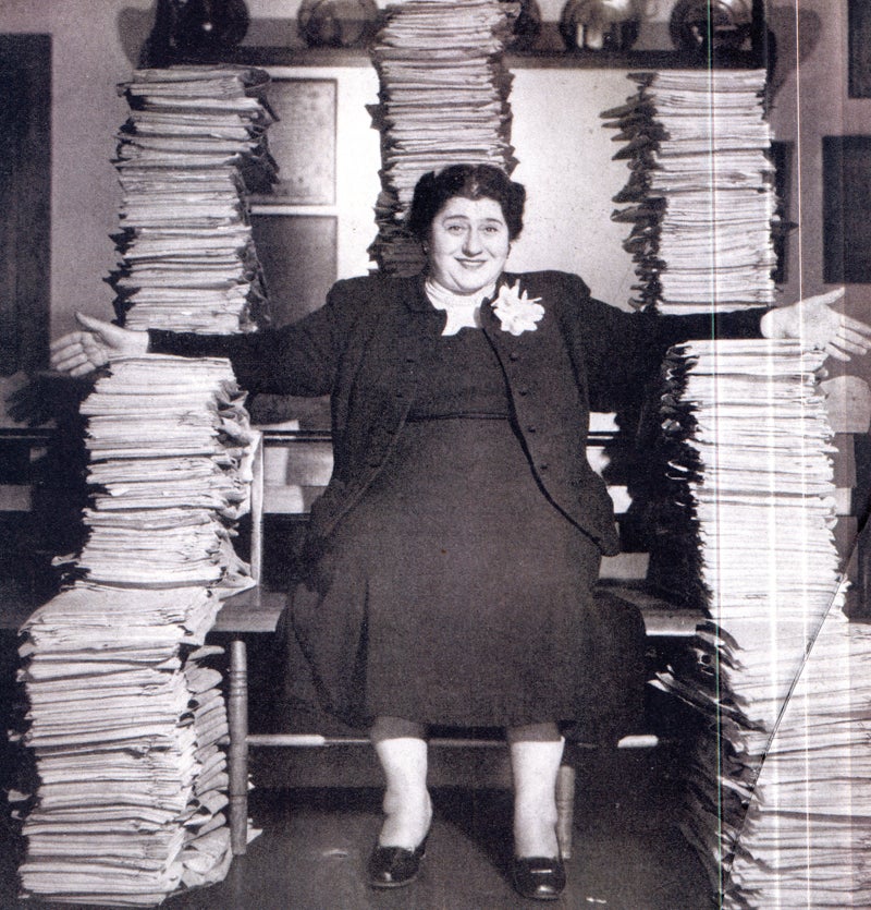 Gertrude Berg, surounded by her scripts